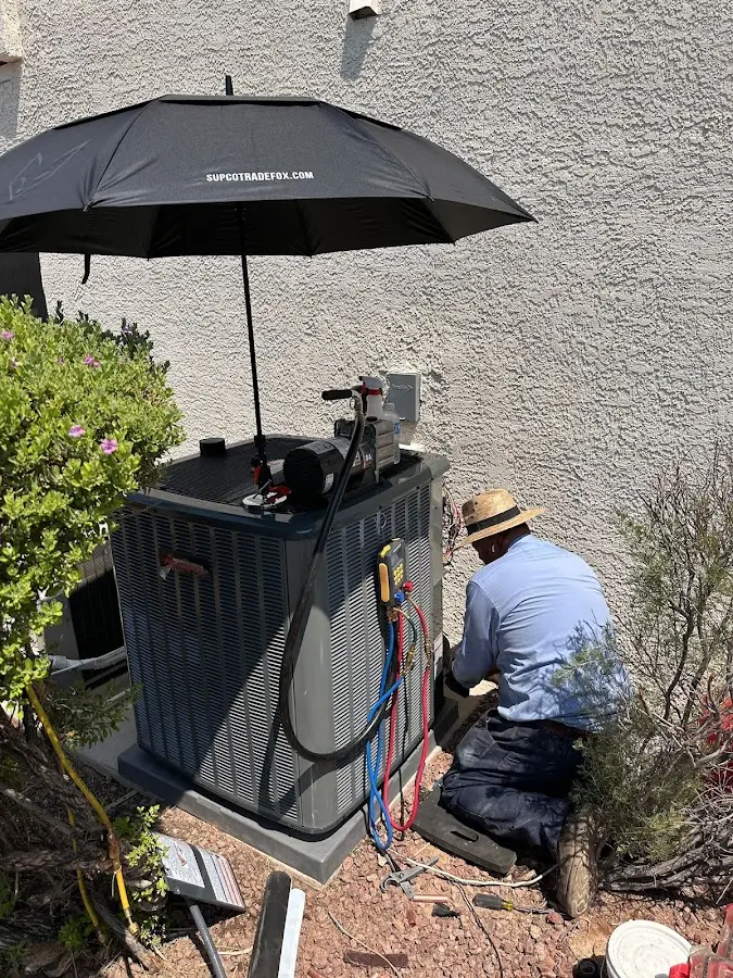 HVAC technician performing outdoor AC maintenance in Geneseo